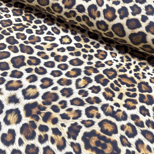 Leopard print upholstery fabric with brown and black spots on a beige background.