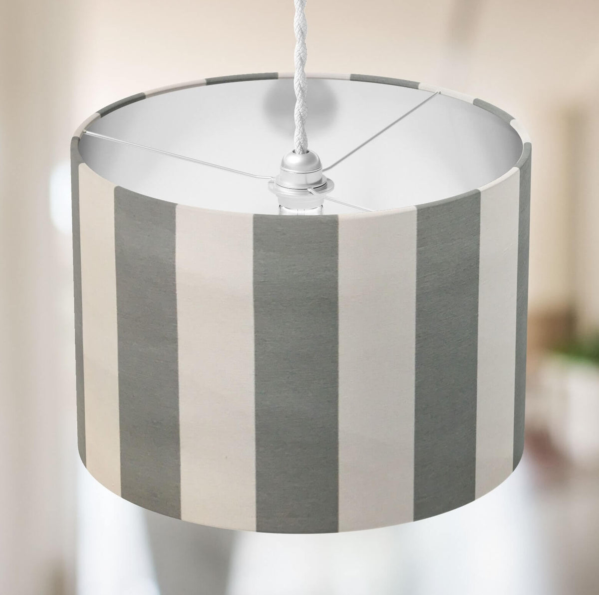 Vertical striped lampshade with gray and white pattern on a neutral background.