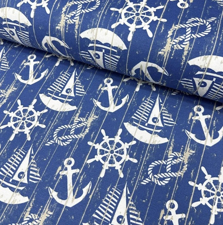 Cotton canvas fabric printed with white sailboats anchors knot ropes ship wheels and blue sea