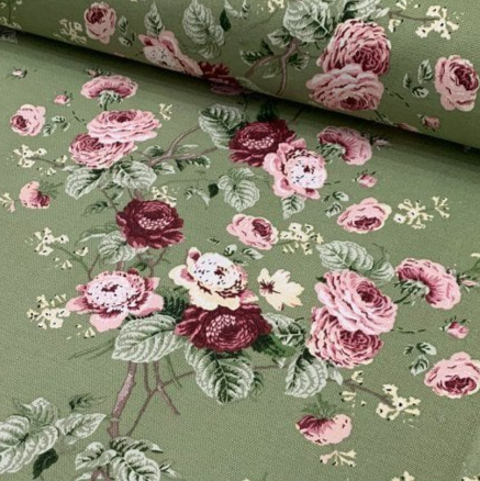 Olive green cotton canvas upholstery curtain fabric patterned with pink burgundy flowers and green leaves.