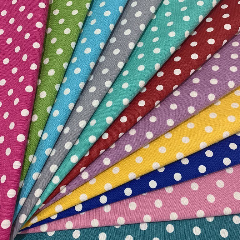 Polka dot upholstery fabric in fuchsia, green, blue, grey, turquoise, red, lilac, yellow, royal blue, pink and teal with white spots.