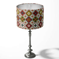 Table and floor lampshade with a brick red, moss green geometric tile pattern on a white background.