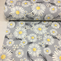 Retro floral upholstery curtain fabric patterned with white daisies on a grey background.