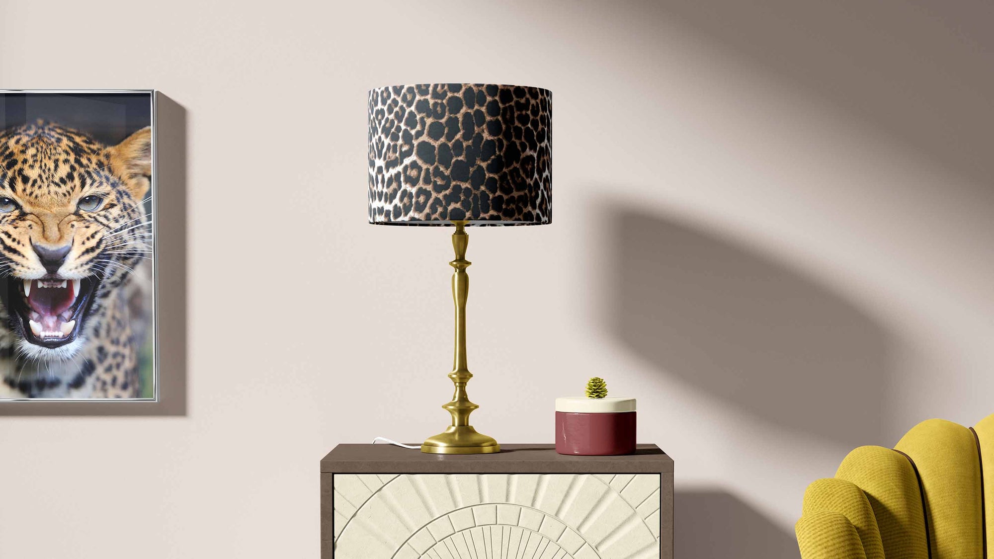 in front of a beige painted wall leopar printed lampshade, mustard sofa and  decorative items.