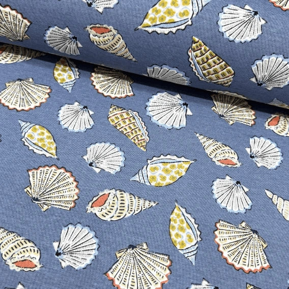 Nautical, coastal seashell print cotton upholstery curtain fabric in indigo blue, white, orange and yellow colours.