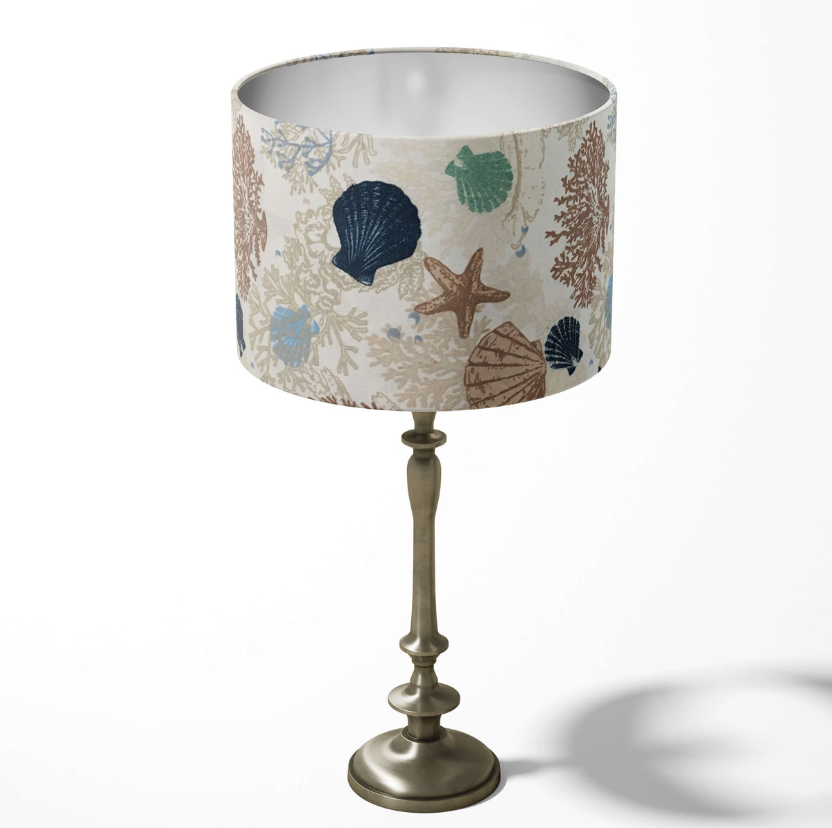 Sea shell and starfish ocean naytical table and floor lampshade in beige and blue.
