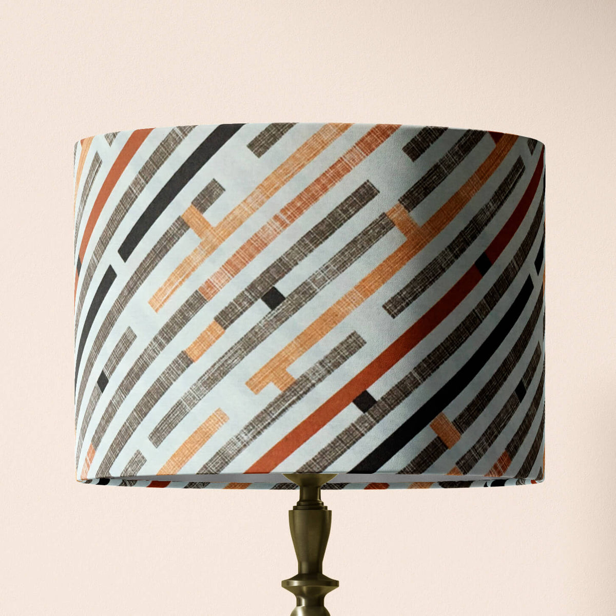 Table lamp shade with geometric pattern on a beige background.