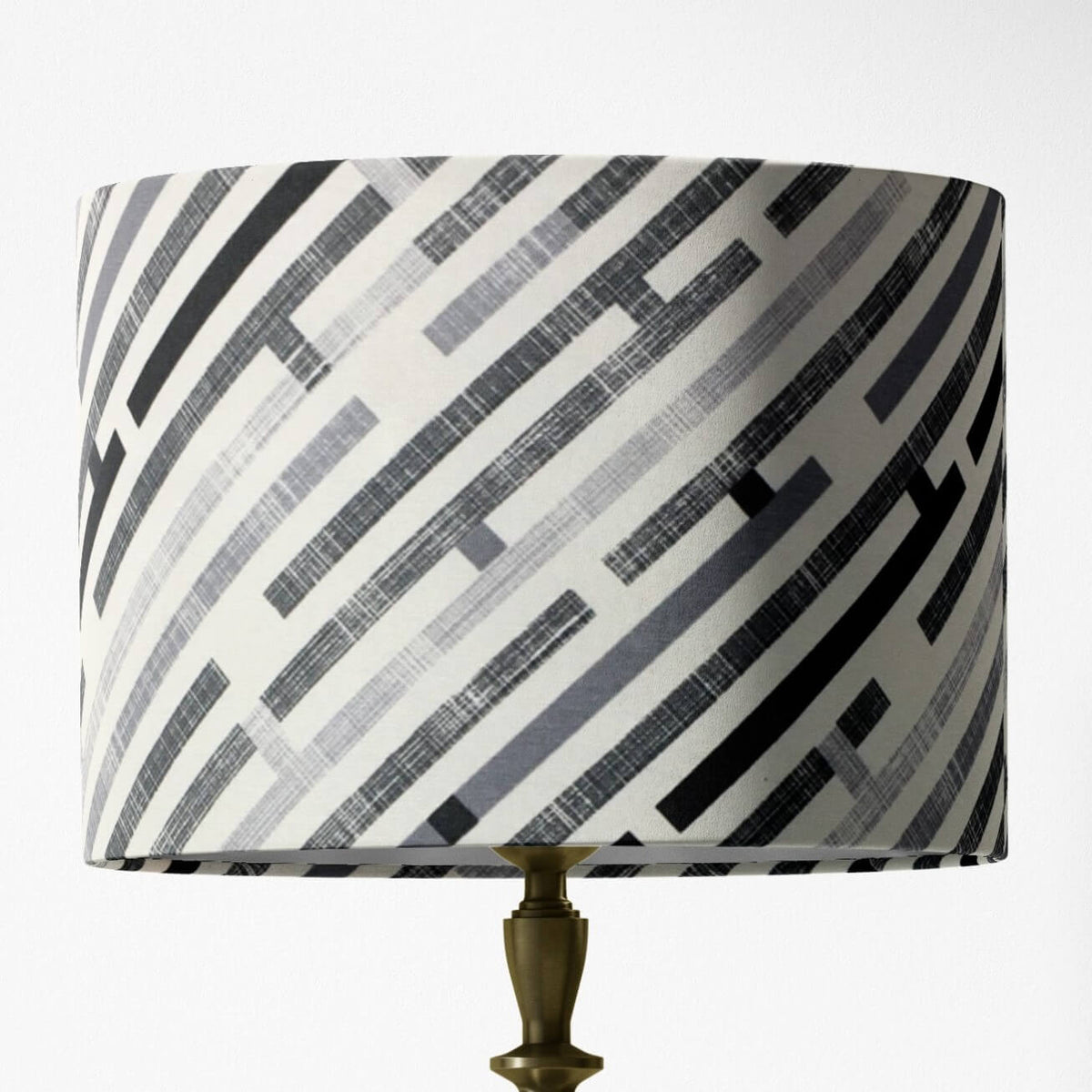 Table lampshade with black, white and gray geometric pattern on a white background.