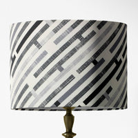 Table lampshade with black, white and gray geometric pattern on a white background.