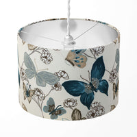 Lampshade with blue butterfly and beige floral pattern on a white background.