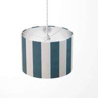 Vertical large striped ceiling lampshade with petrol blue and white pattern on a white background.