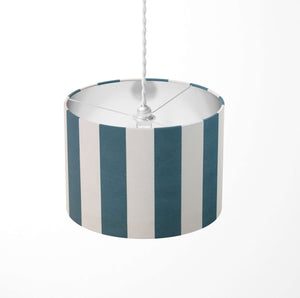 Vertical large striped ceiling lampshade with petrol blue and white pattern on a white background.