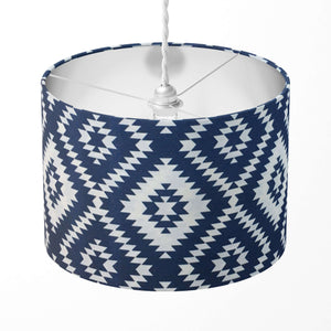 Tribal lampshade with blue and white geometric pattern on a white background.