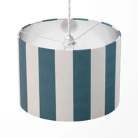 Vertical striped lampshade with teal blue and white stripes on a white background.