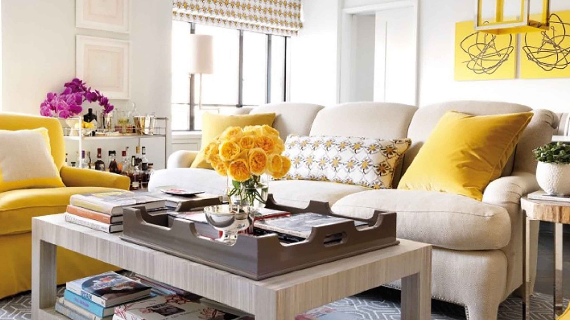 Living room with yellow and white decor, including a sofa, coffee table, and decorative items.