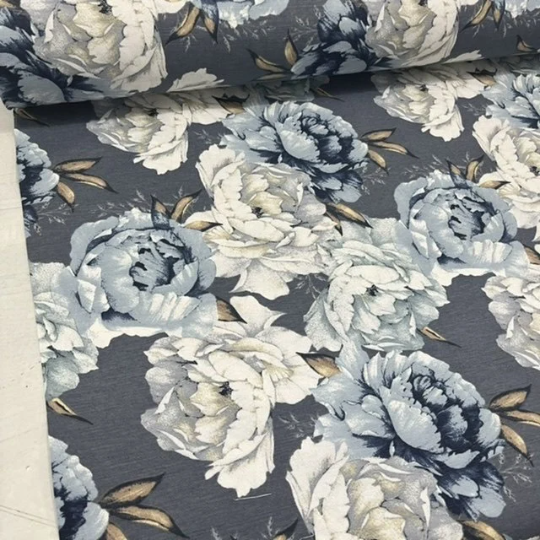 A fabric featuring a large rose design in shades of blue and white, suitable for upholstery and home decor.