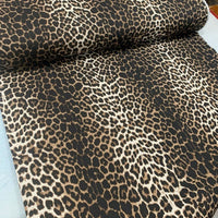 Leopard print fabric suitable for upholstery and home decor.