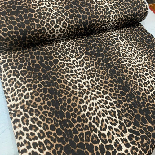 Brown leopard print fabric suitable for upholstery and home decor.