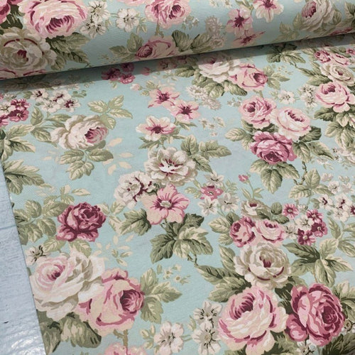 roses upholstery fabric with a shabby chic floral pattern in pastel colors, primarily pink and mint green