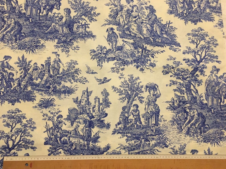 Blue toile upholstery & curtain fabric picture showing pattern repeat with a ruler.